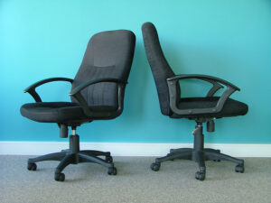 Two black office chairs next to each other
